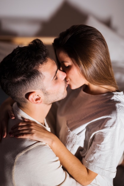 lady-guy-kissing-hugging-bed-dark-room-23-2148020324